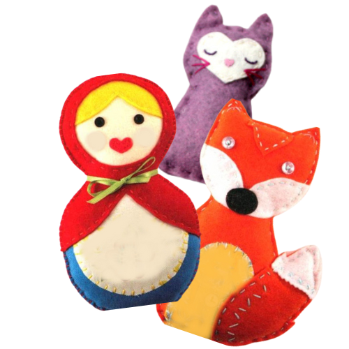 Several different handsewn stuffies, a marushka doll, a fox and a kitty