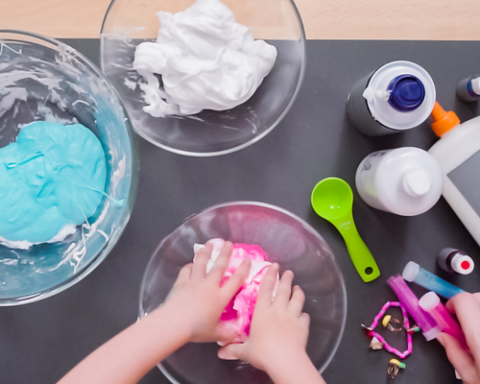 Overhead photo of hands making slime from various ingredients