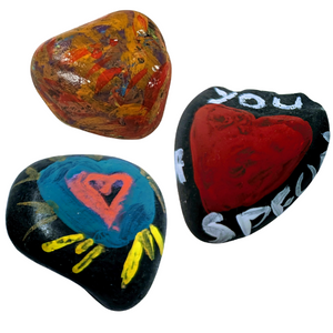 A selection of heart shaped and themed Kindness Rocks painted by previous event attendees
