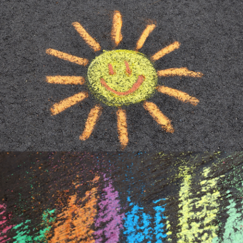 A chalked sun rises above red, green, orange, purple, blue and lime chalk stripes on a blacktop background.