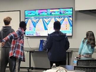 Tweens and Teens playing Switch Sports Bowling at the Library